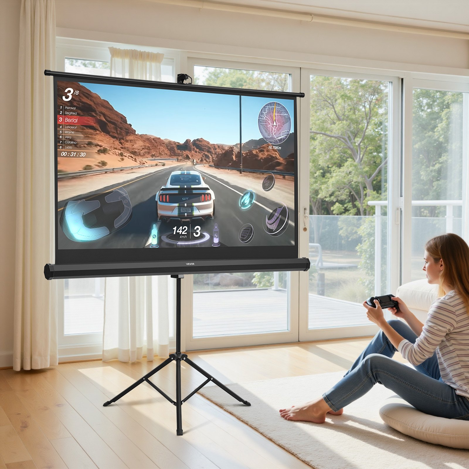 Portable projector screen displaying a racing game; user seated with game controller in a bright indoor setting.