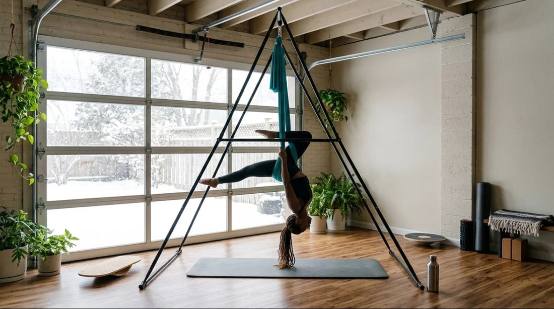 Woman doing aerial yoga on a freestanding yoga stand frame in a bright garage studio on a snowy day